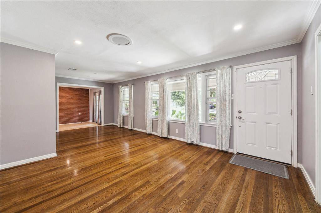 Large living room with tons of natural light emitted through many windows
