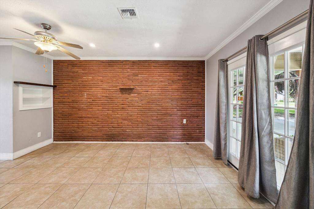 Den adjacent to the living room functions as formal living, formal dining or game room
