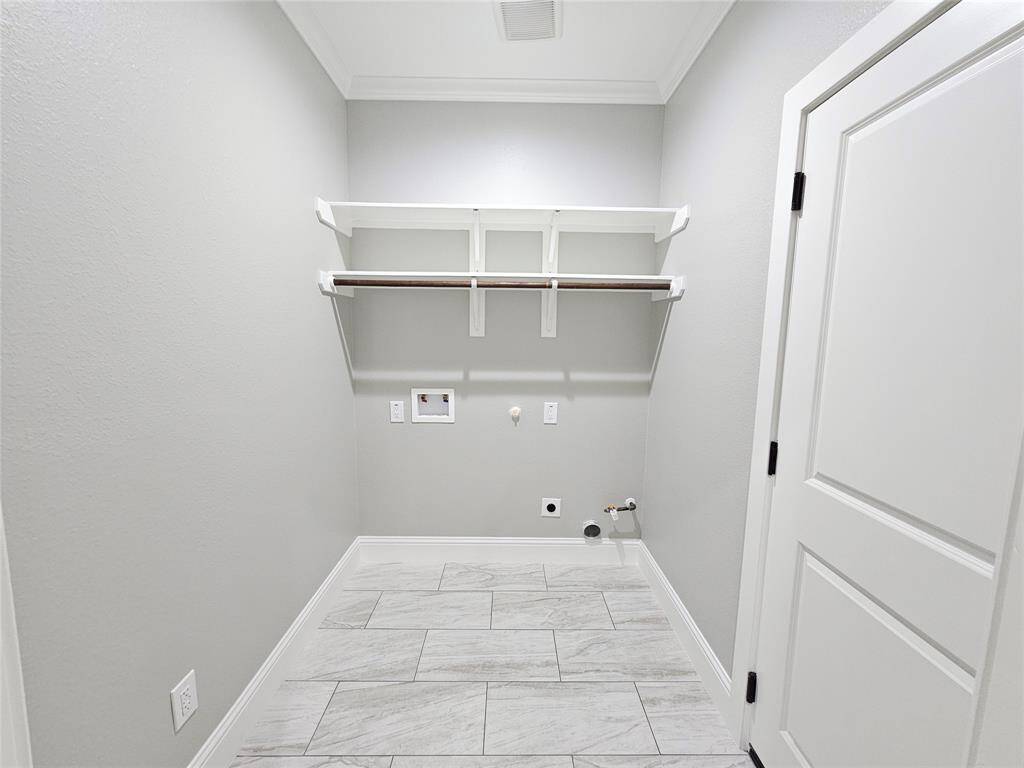 This is the Laundry room and has access to the garage! It has plenty of space for storage or to decorate as you like.