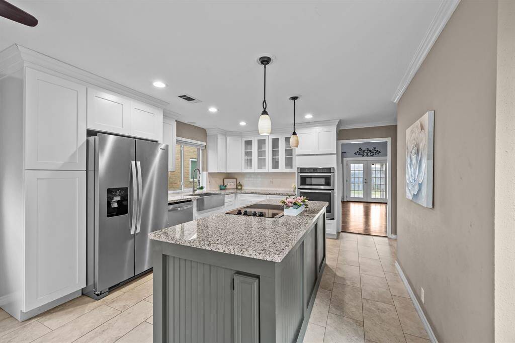 This kitchen features elegant details and a convenient hidden spice rack in the island.