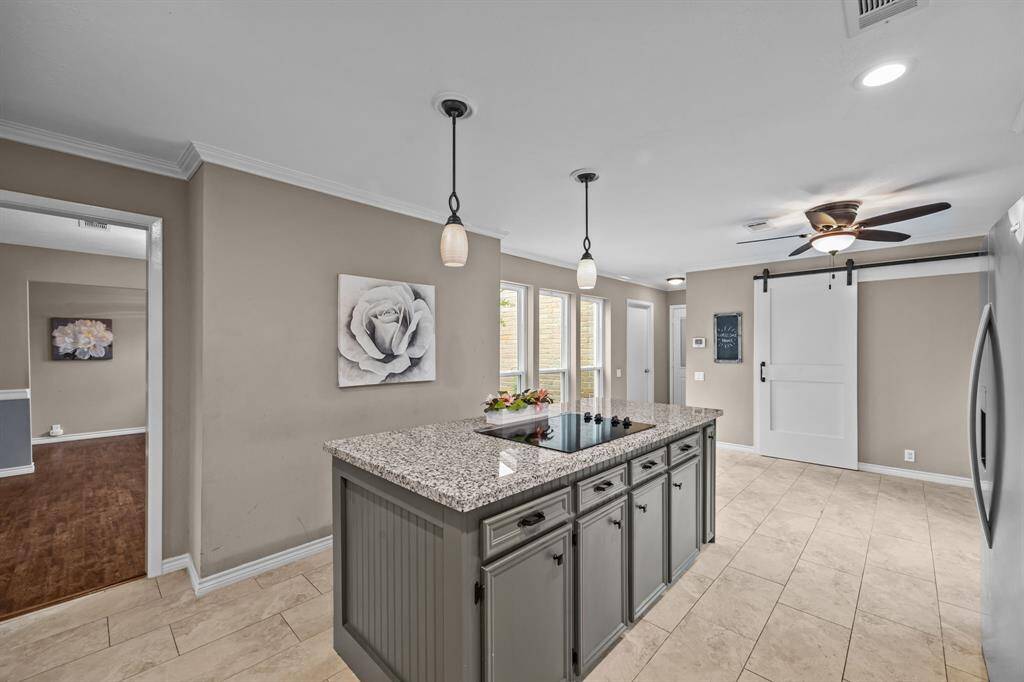 The island features and electric stove top and tons of extra storage.