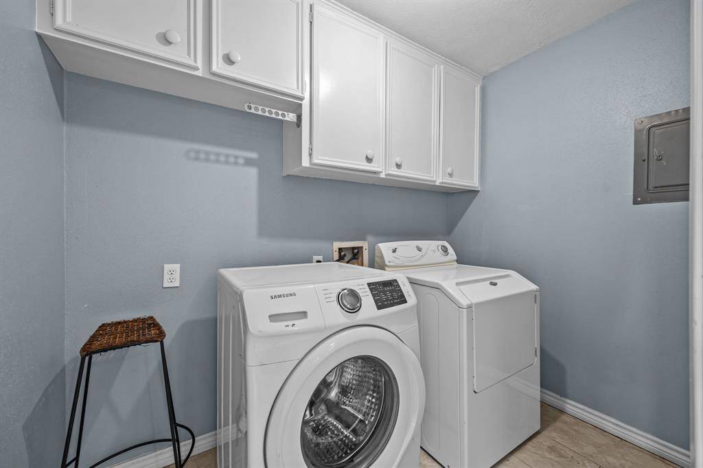 Spacious laundry room with convenient built-in shelving, ideally located off the kitchen.