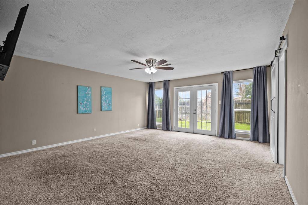 Expansive primary suite with direct backyard access.