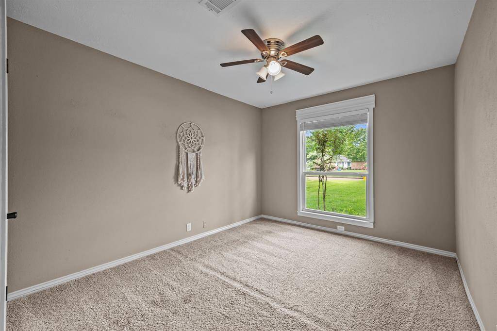 Bright third bedroom with abundant natural light.
