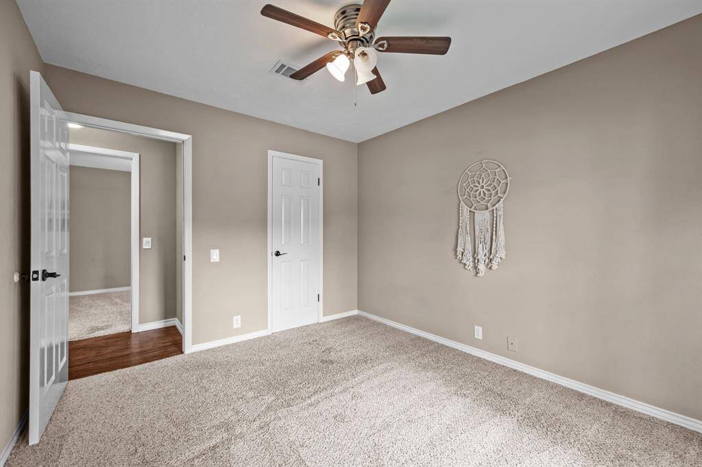 Versatile third bedroom with ample natural light and cozy carpeting.