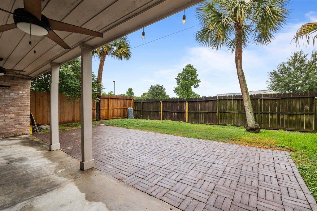 Enjoy privacy in this spacious backyard with a covered patio and no rear neighbors.