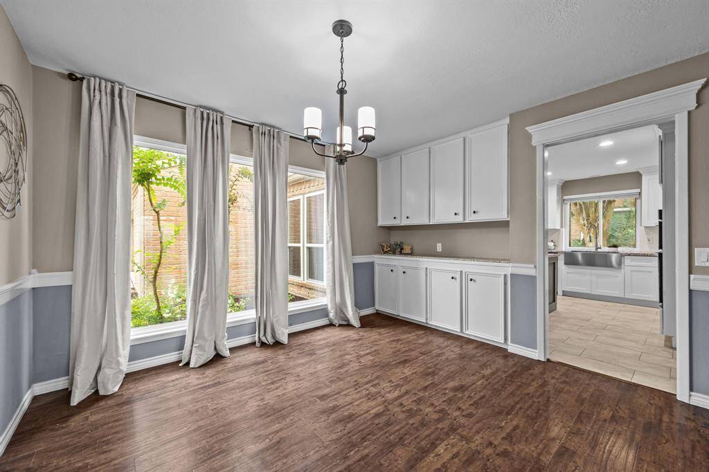 Bright dining room with ample built-in storage and abundant natural light.