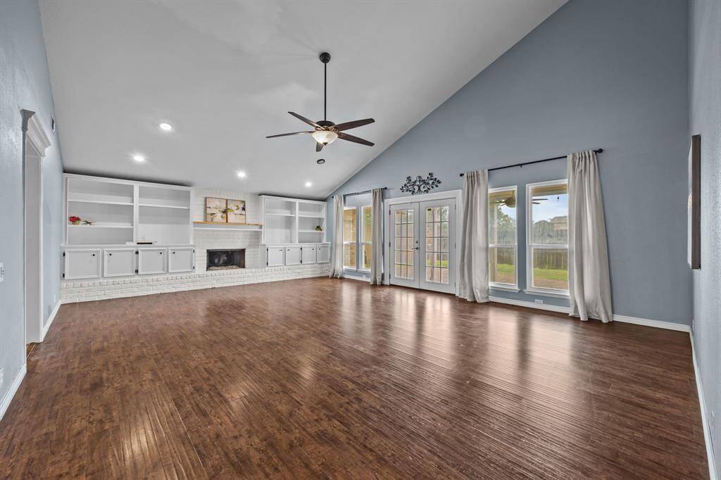 Spacious family room with built-in storage and abundant natural light.