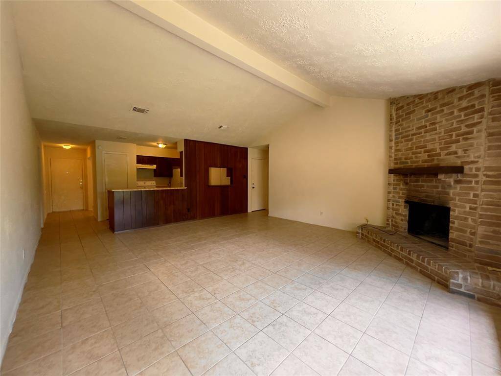 Another view of the living room with the kitchen.