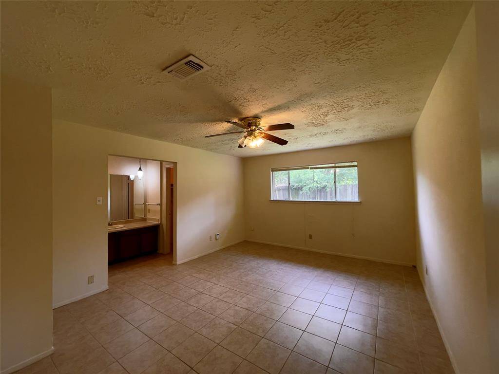 Primary bedroom with ensuite bathroom and closet space.