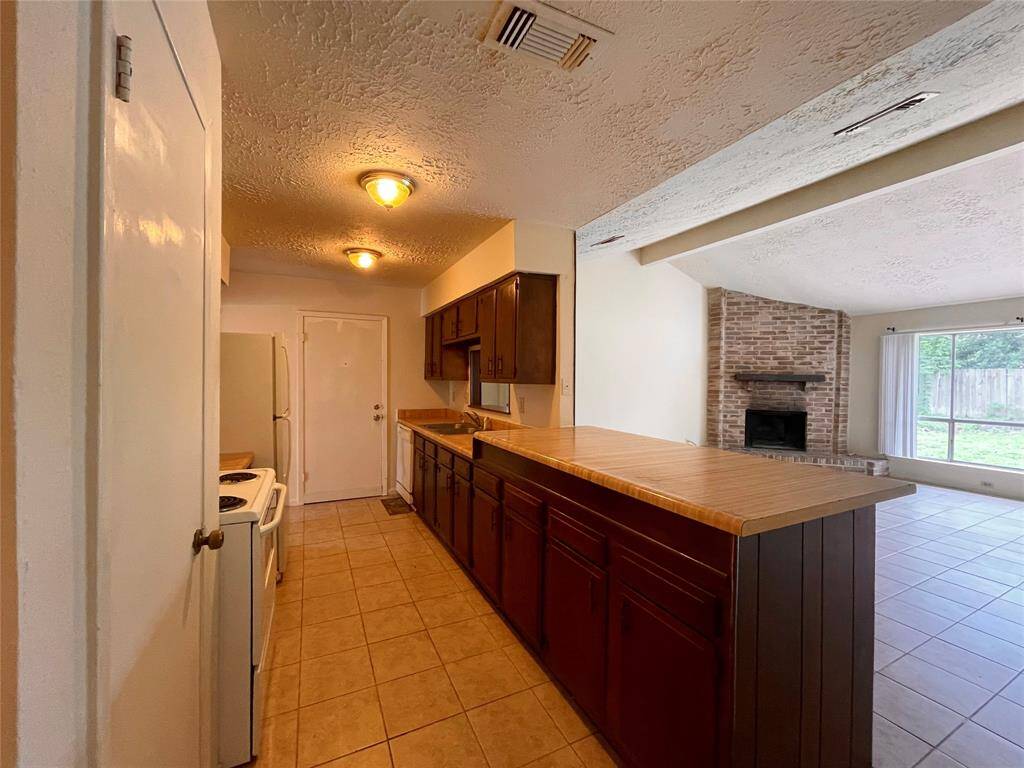 Kitchen with large open butcher block countertop.