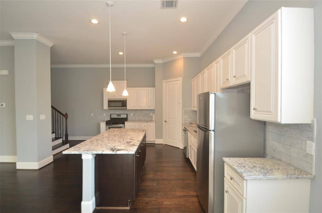 Photos from previous listing. View of kitchen from breakfast area.