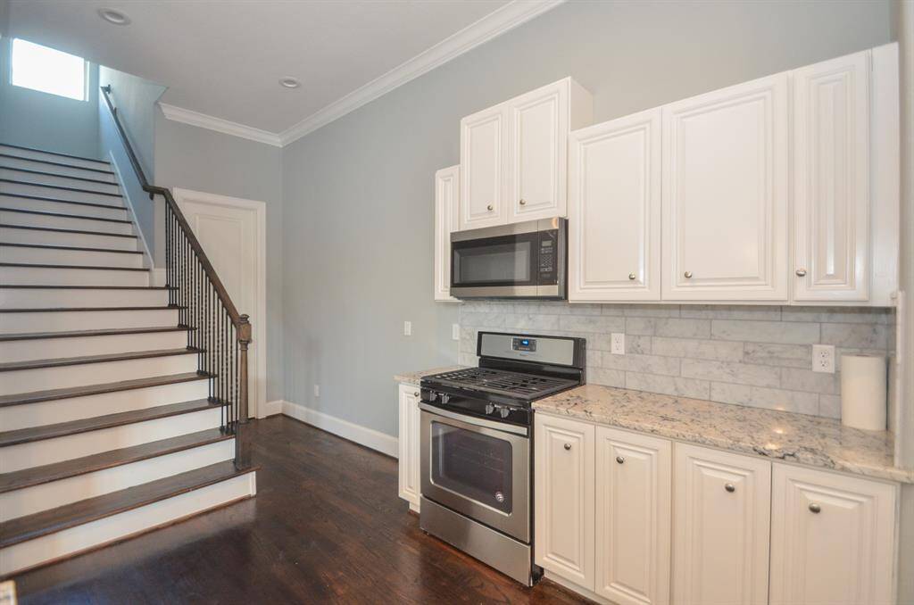 Stairs leading up to the third floor with master bedroom and bedroom #3.  The Photos from previous listing. Door leads to a half bath.