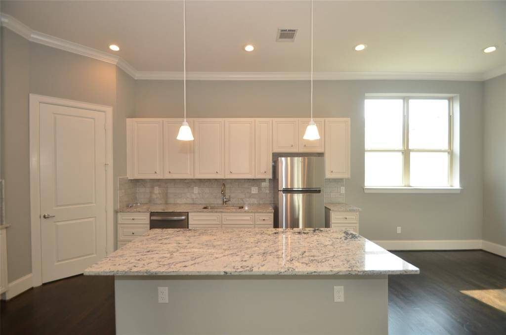 Photos from previous listing. Huge island with room for bar stools. Lots of serving and prep space for all your cooking and entertaining needs.