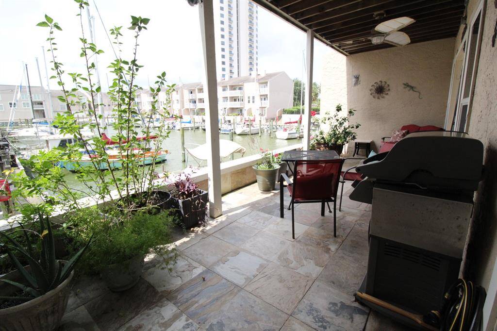 Large and spacious balcony over looking marina and clear lake with a view to the pool.