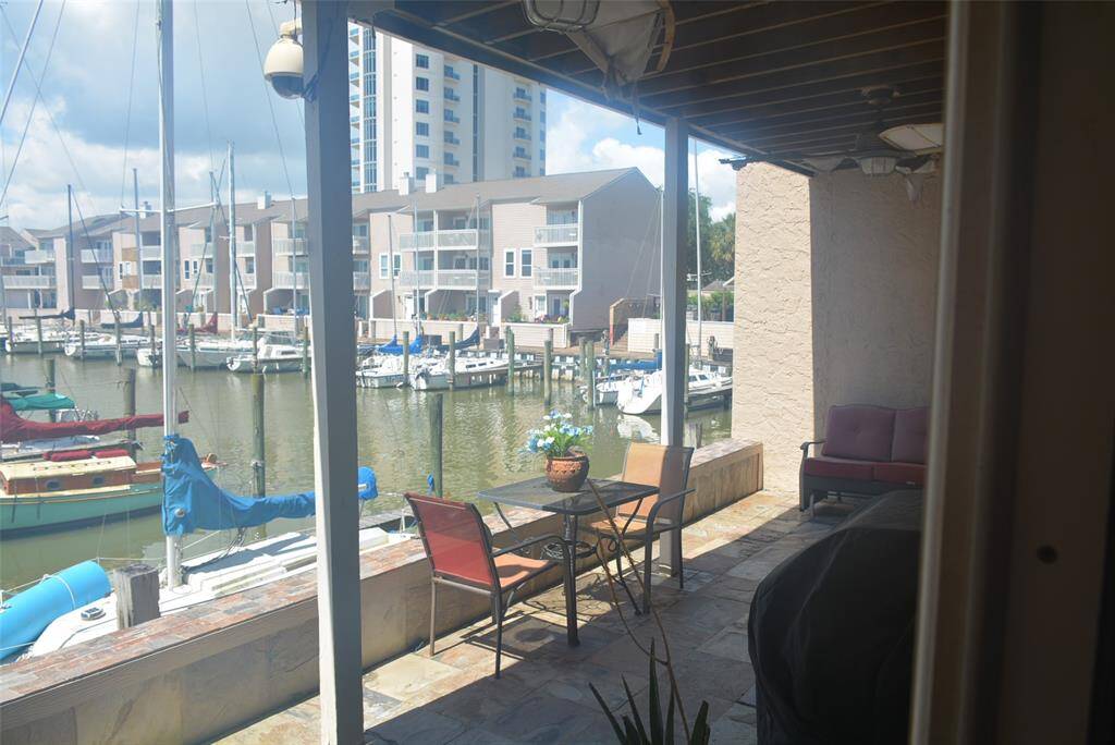 Step into a versatile space featuring a formal dining area, currently showcasing a pool table, with a sleek modern kitchen just steps away. Enjoy the convenience of a stylish wet bar and easy access through the nearby main entrance.