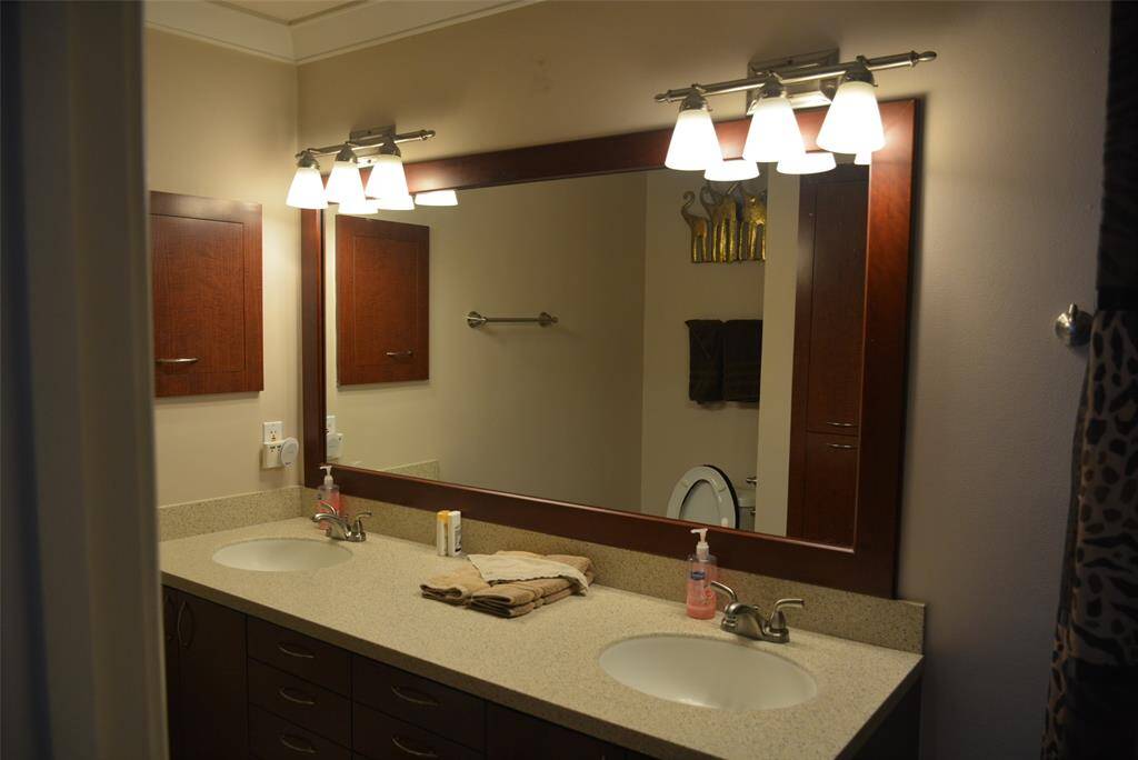 Step into a versatile space featuring a formal dining area, currently showcasing a pool table, with a sleek modern kitchen just steps away. Enjoy the convenience of a stylish wet bar and easy access through the nearby main entrance.