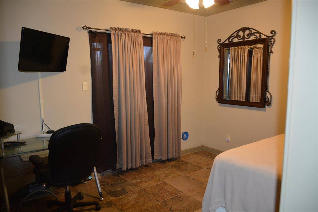A wet bar adds elegance to this versatile space featuring a formal dining area, currently showcasing a pool table, with a sleek modern kitchen just steps away. Enjoy the convenience of a stylish wet bar and easy access through the nearby main entrance.