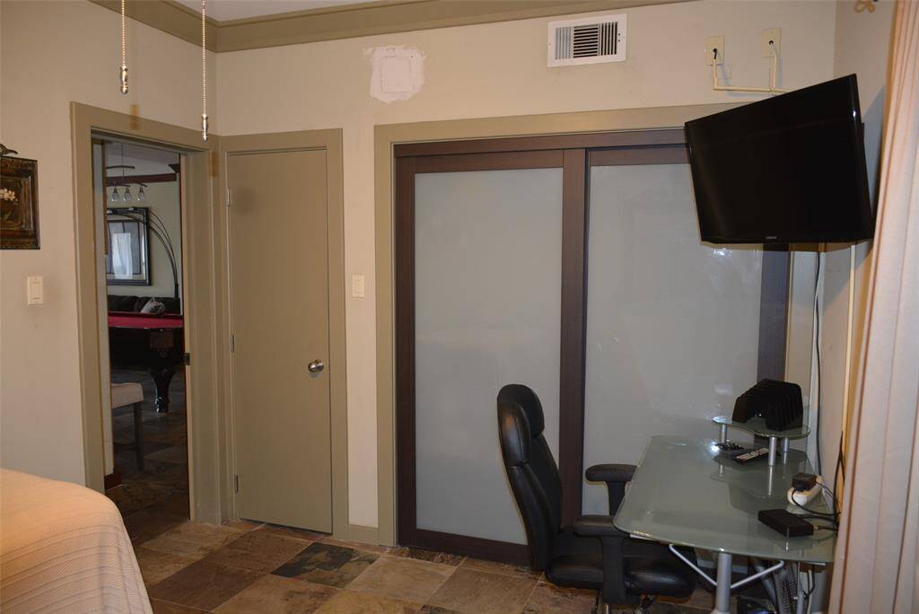 Step into a versatile space featuring a formal dining area, currently showcasing a pool table, with a sleek modern kitchen just steps away. Enjoy the convenience of a stylish wet bar and easy access through the nearby main entrance.