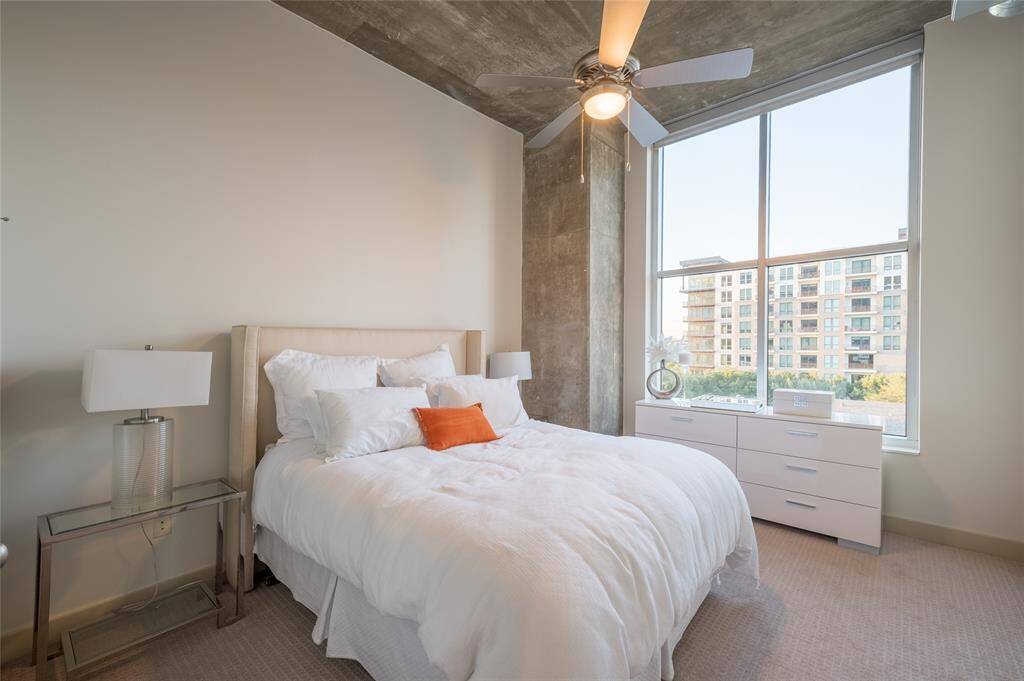 The secondary bedroom boasts an abundance of space and of natural light! It may serve as a guest room or an office space comfortably.