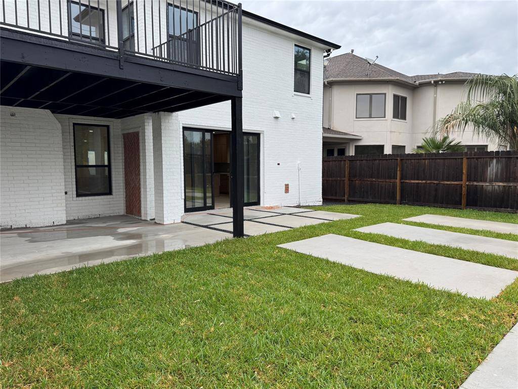 Backyard space includes covered patio and \ plumbed for outdoor kitchen.