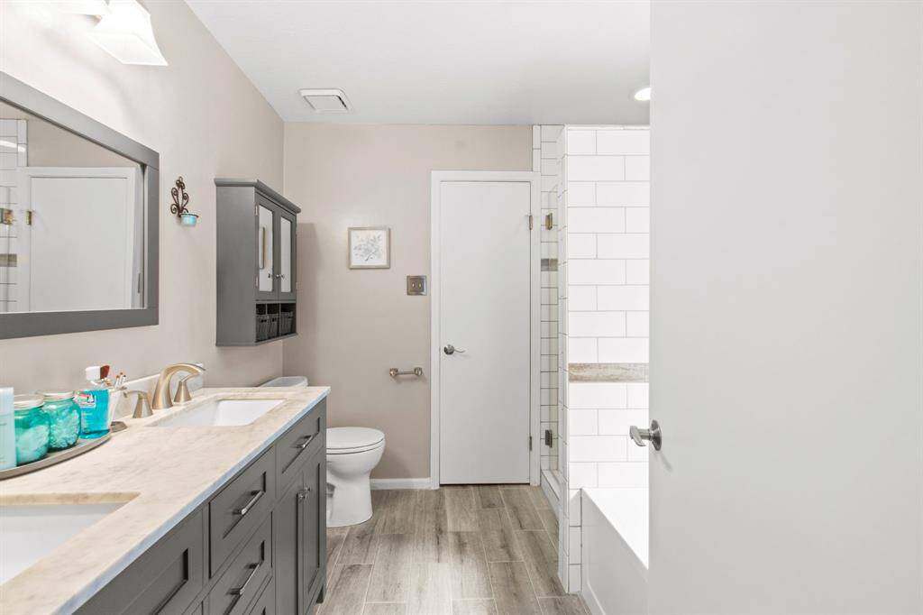 Stylish primary bathroom featuring modern fixtures, sleek cabinetry, and elegant tile work for a serene retreat.