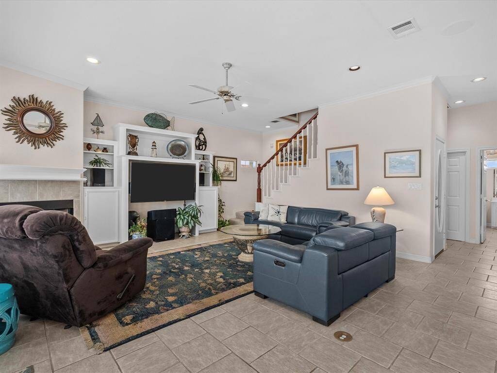 Recessed lighting and ceiling fans contribute to the comfortable ambiance.