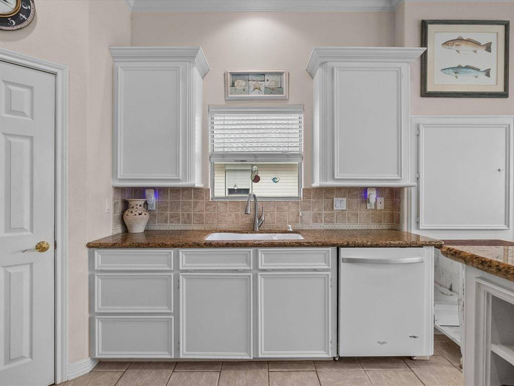 A window above the sink allows for natural light, and the overall design creates an efficient and appealing culinary area.