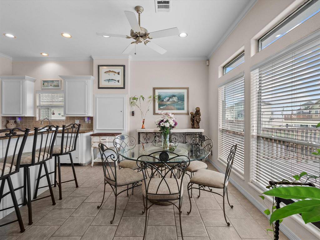Large windows with blinds and transom windows above allow abundant natural light to fill the room.