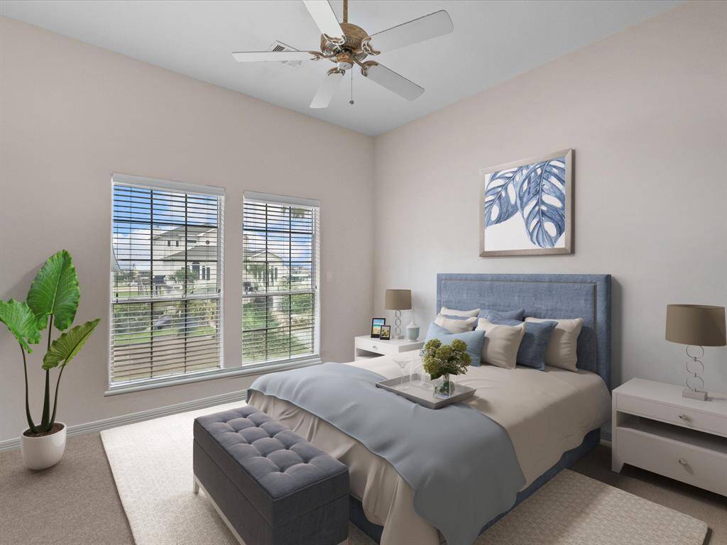 The second large main level bedroom has a 2 windows with a view and spacious closet, all finished with neutral-color wall hues.