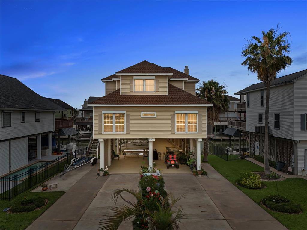 This stunning elevated residence has ample ground-level space for parking and outdoor activities.
