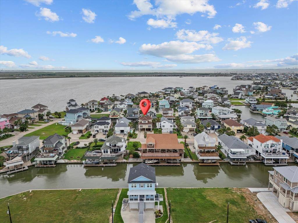The surrounding neighborhood showcases a variety of custom homes, many with private boat slips and docks, that emphasize the nautical lifestyle.