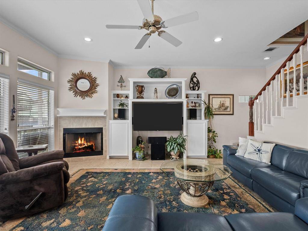 The living room features a cozy corner wood burning fireplace, plus built in storage and is perfect for relaxation.