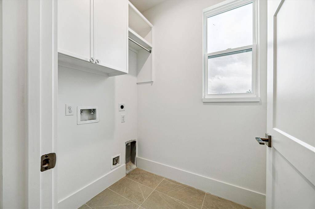A full laundry room with additional storage.