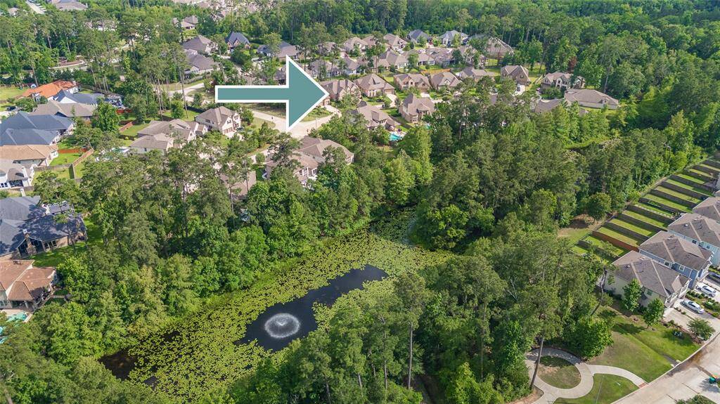 This home is nestled near several picturesque lakes and embraced by a serene canopy of trees.