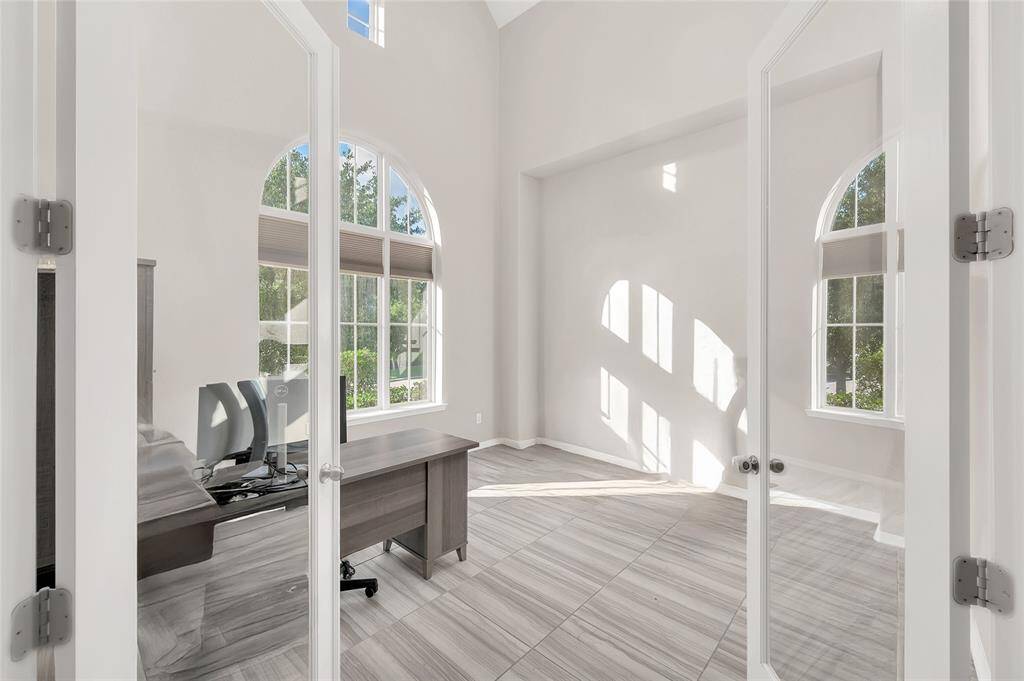 Private home office with a 2story ceiling featuring French Doors.