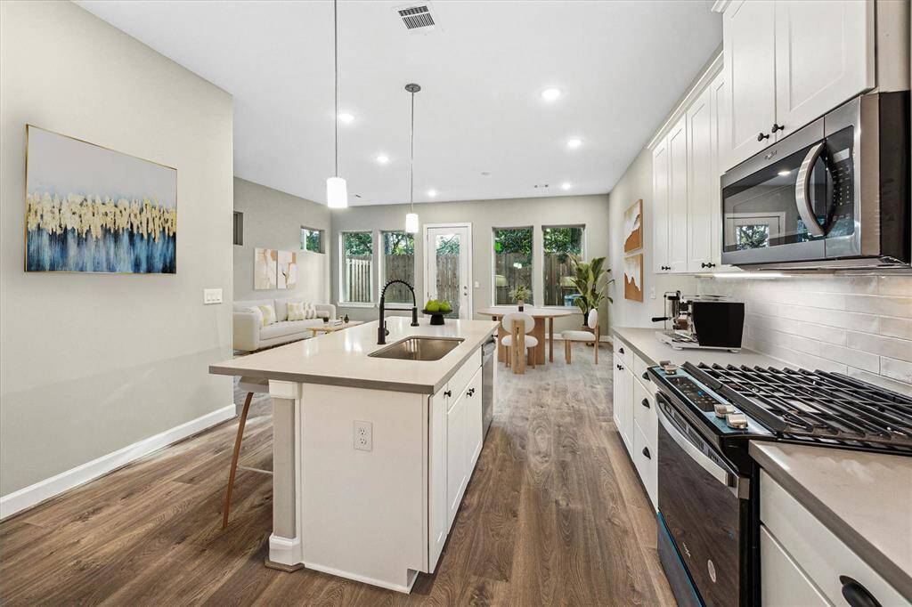 Enjoy sightlines to the backyard and living area while prepping meals at the island—ideal for entertaining or everyday multitasking.