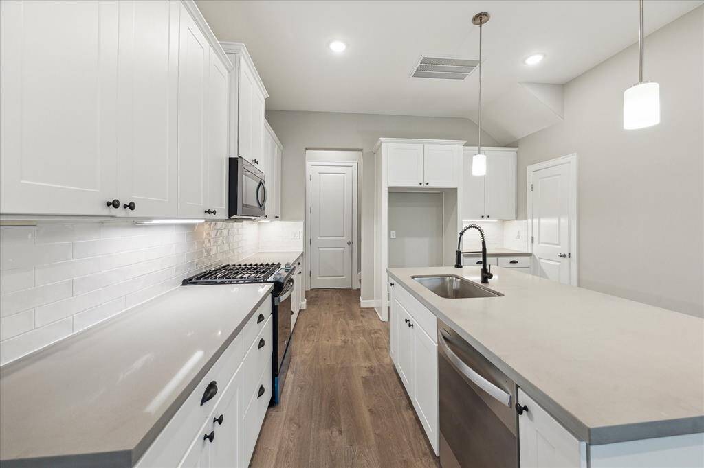 From cooktop to cleanup, this kitchen layout is as efficient as it is stylish—with plenty of prep space and pantry storage.