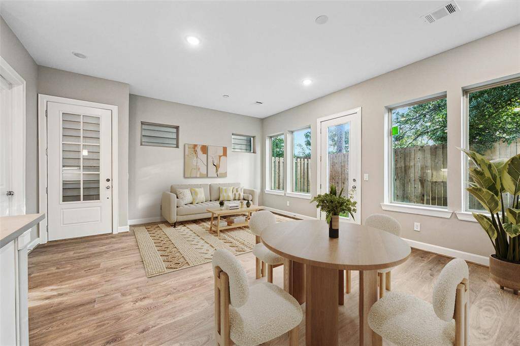 A wall of windows invites the outdoors in, creating a tranquil connection between indoor living and your private yard.