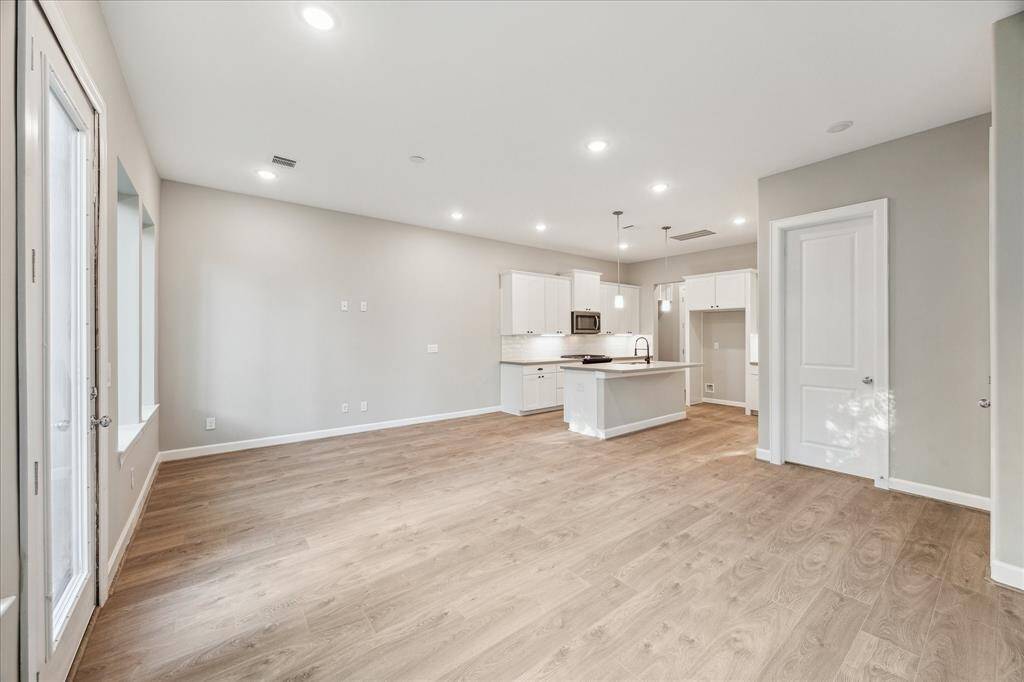Floor-to-ceiling natural light meets neutral tones for a calming, move-in ready living space.