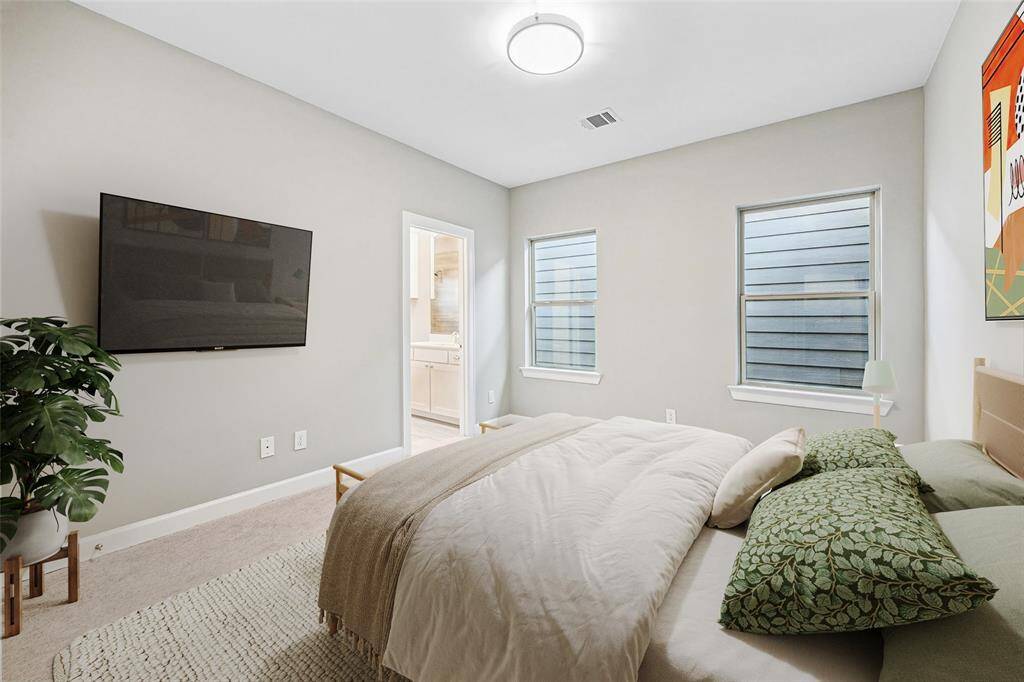 Perfect for guests or a stylish office setup, the secondary bedroom is bright, serene, and smartly laid out.