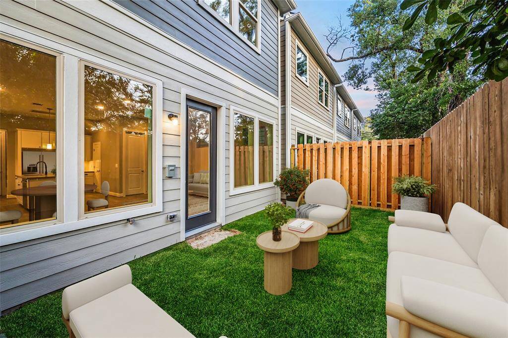 Fenced and private, the backyard is prepped for cozy firepit nights and weekend lounging in the heart of the city.