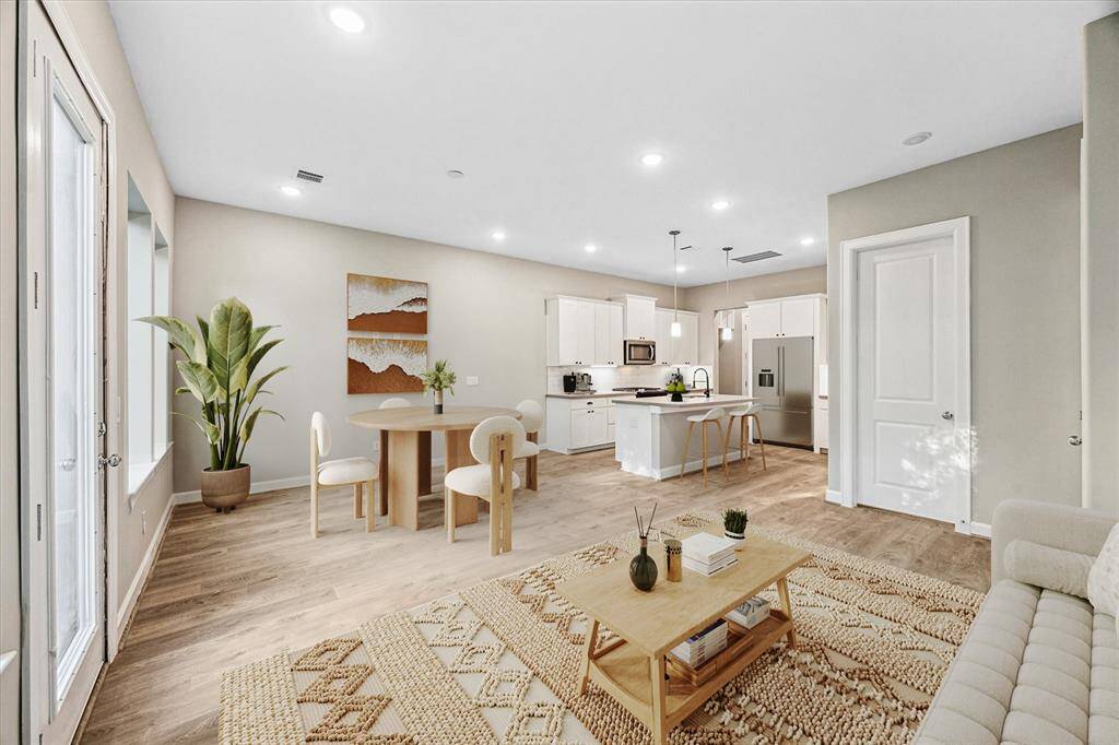 Sunlight floods the open living space, blending effortlessly with dining and kitchen areas for seamless everyday living and elevated entertaining.