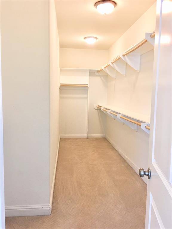 Huge walk-in closet with storage shelf/combinet on the left