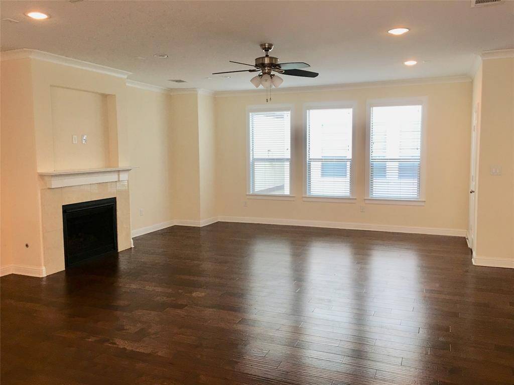 View of spacious living room with gas fireplace.