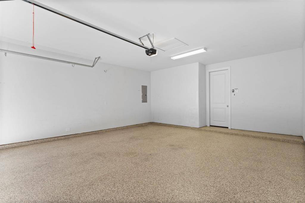 Spacious two-car garage with finished flooring, overhead lighting, and direct access to the home.