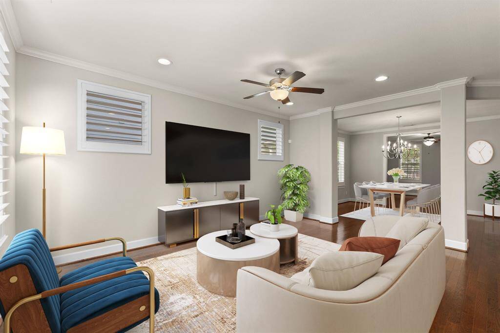 Bright and inviting living room with recessed lighting, ceiling fan, and open flow into the dining area—perfect for relaxing or entertaining.
