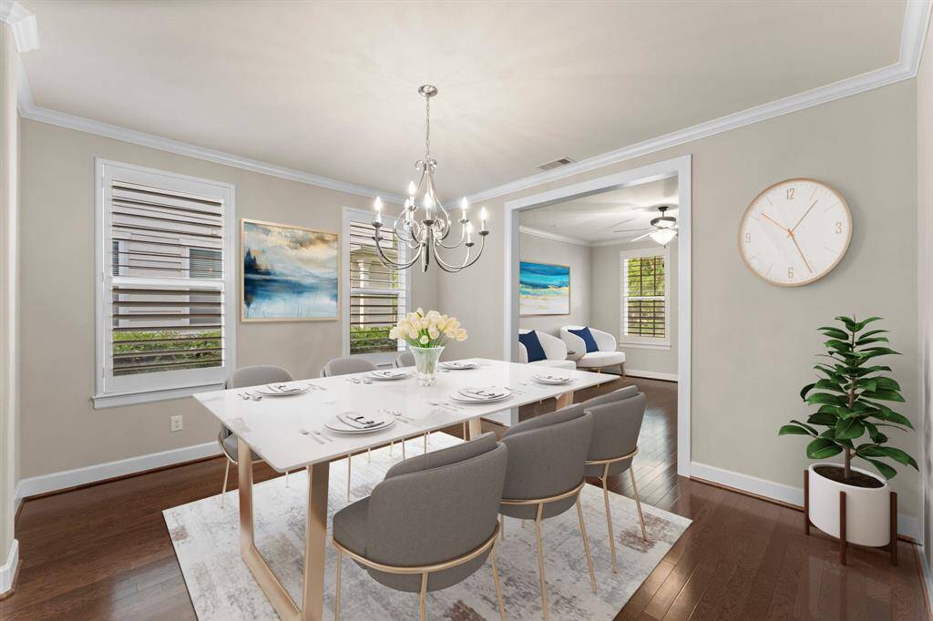 Elegant formal dining room with crown molding, abundant natural light, and direct access to a cozy sitting area—perfect for entertaining.