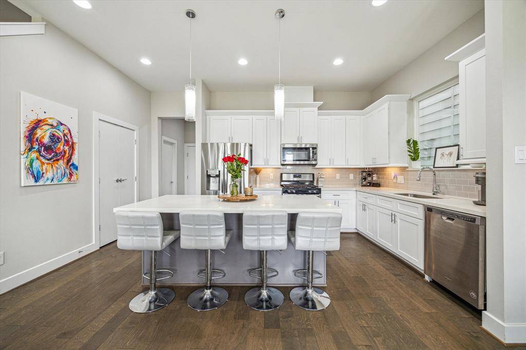 The grand kitchen includes a refrigerator and wine fridge.