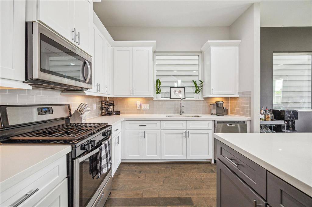 White quartz countertops and soft-close cabinets and drawers in the kitchen.